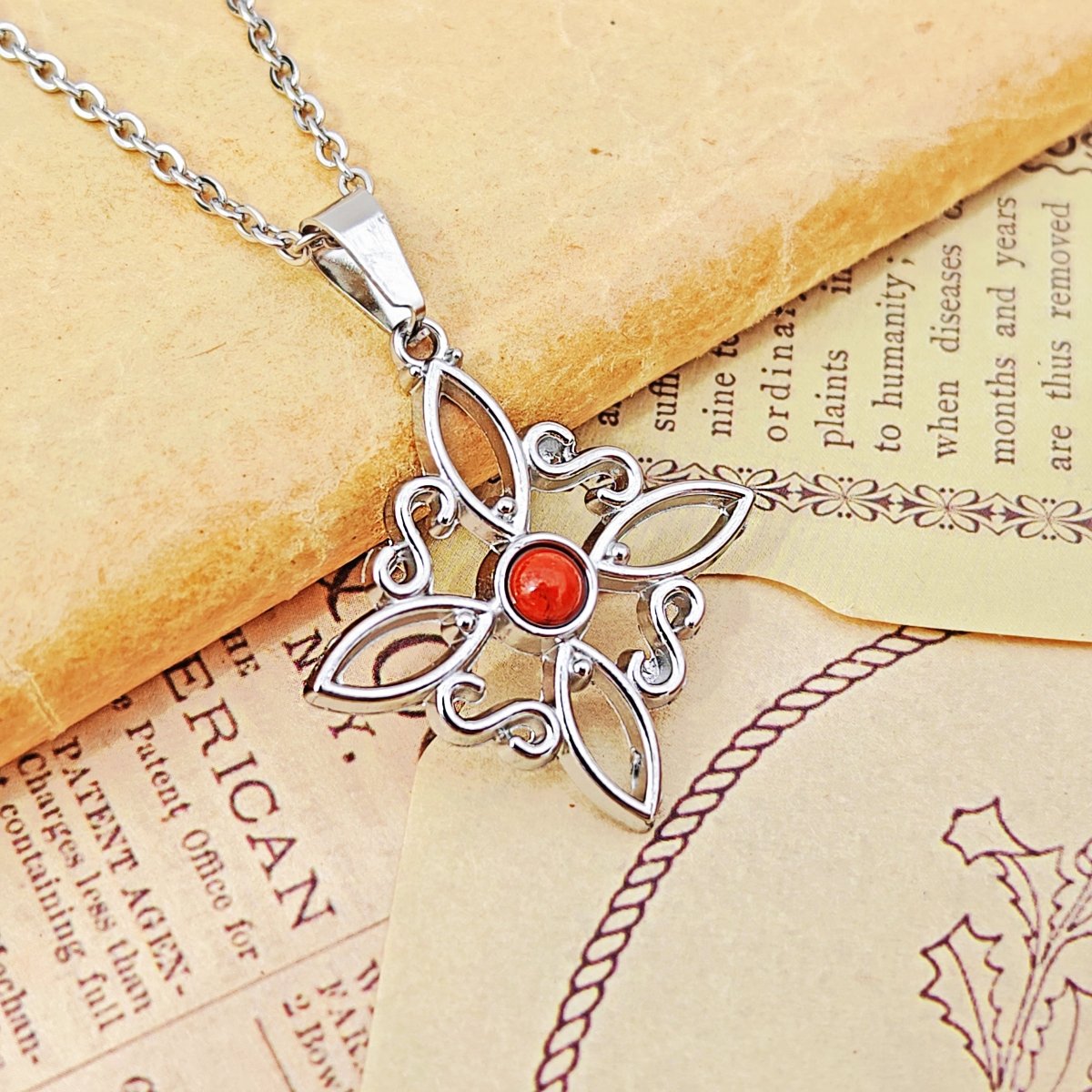 Collar Nudo de Bruja Acero Inox. con Jaspe Rojo