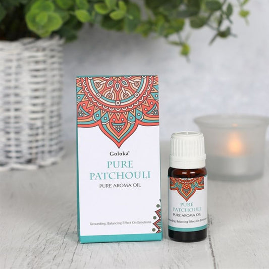 Esencia de pachulí Goloka en frasco de cristal, aroma terroso y amaderado, para aromaterapia y bienestar natural.