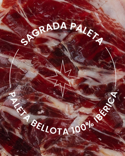 Jamón ibérico de bellota 100% Monjamo y Más, con vetas de grasa y corte en la esquina, sobre fondo blanco.