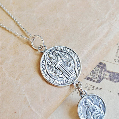 Colgante doble protección con San Benito y San Judas Tadeo en plata de ley 925, símbolo de fe y protección.