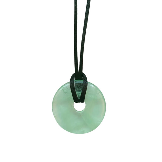 Colgante de mineral Donut de Fluorita Verde, joya de piedra natural con acabado pulido, en un fondo neutro.
