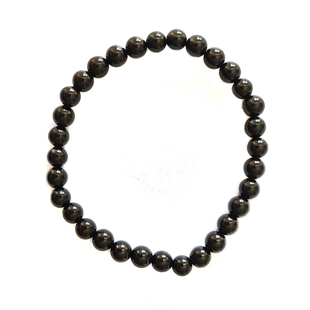 Pulsera de mineral Ónix con bolas lisas, accesorio de moda de Mystical Tienda, muestra las bolas negras pulidas en la imagen.