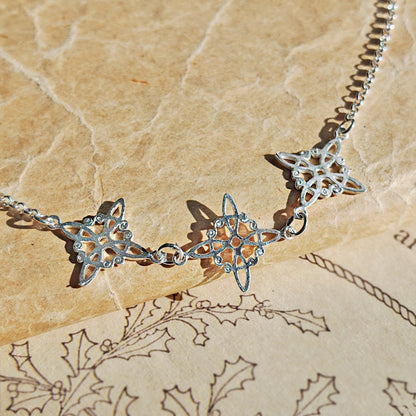 Pulsera de plata de ley 925 con triple nudo de bruja, joya de estilo místico y elegante.